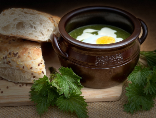 Nettle soup with egg in a traditional Swedish Höganäs pot with seeded bread on the side
