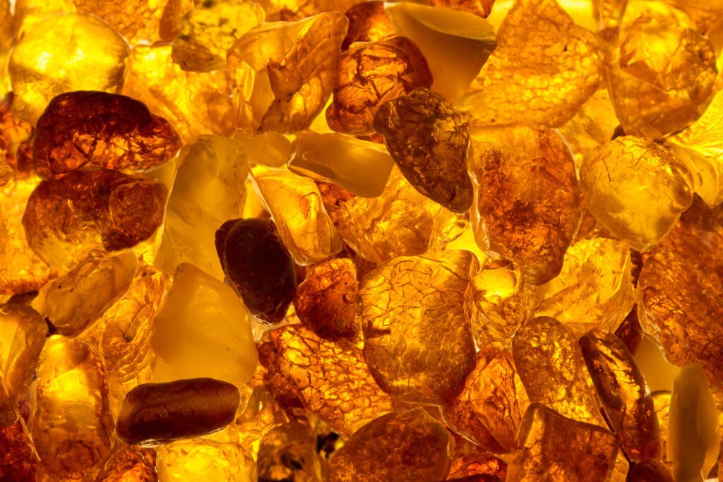 Amber, a resin in different hues of gold, orange and yellow.